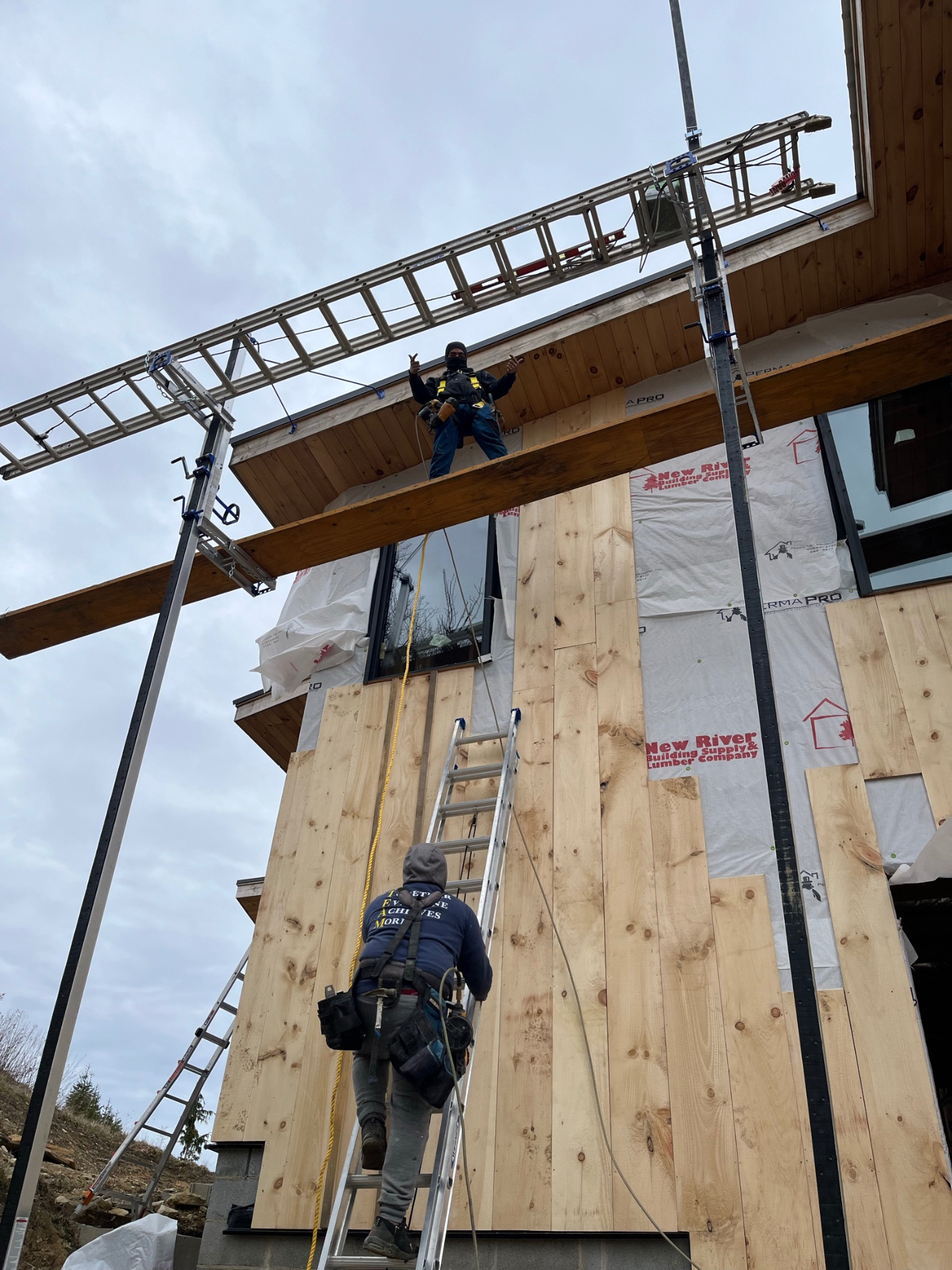 Rep Construction crew installing cedar siding